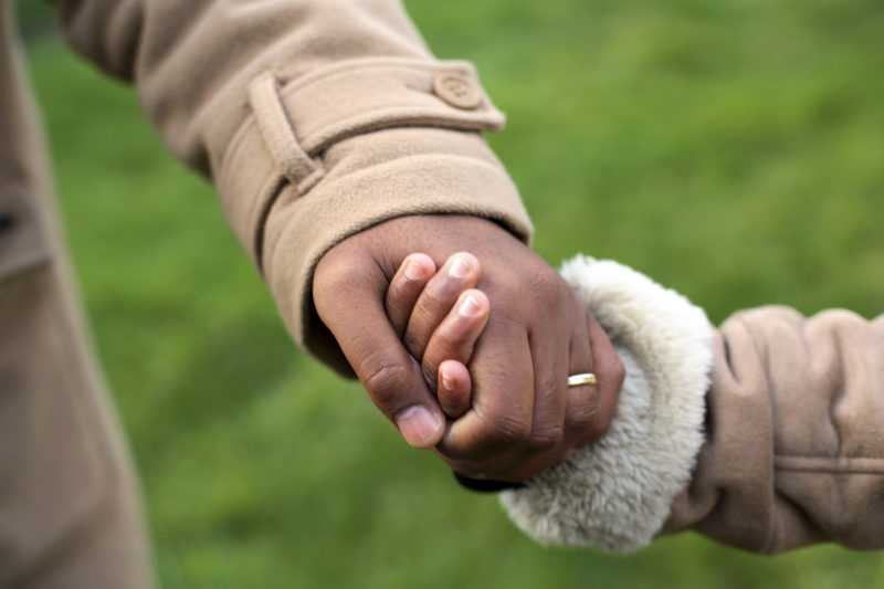 Child holding mother's hand. Custody of children is a sensitive issue, and rarely do children want to be separated from their parents.